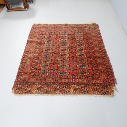 2327 - An antique red-ground Afghan rug. 142x125cm.