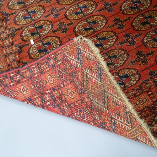 2327 - An antique red-ground Afghan rug. 142x125cm.