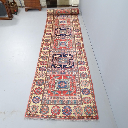 2328 - A cream-ground Caucasian runner. 422x82cm.