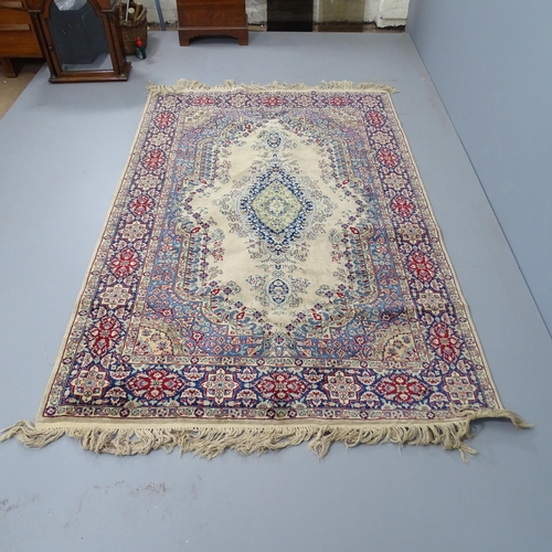 2329 - A cream-ground Kerman rug. 220x140cm