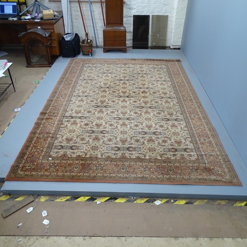 2331 - A machine made salmon-ground floral carpet. 297x203cm.