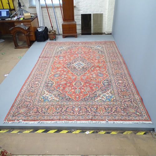 2338 - A red-ground Kashan carpet. 305x203cm