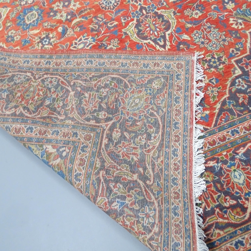 2338 - A red-ground Kashan carpet. 305x203cm