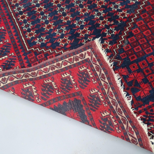 2340 - A red-ground Afghan rug. 183x115cm