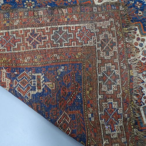 2346 - An antique blue-ground Persian rug. 185x160cm