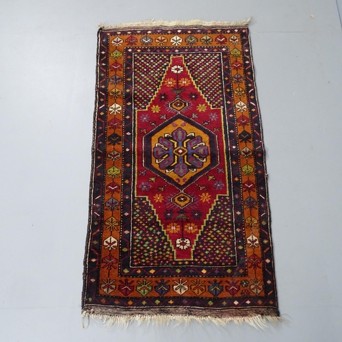 2348 - A handmade Persian red-ground rug. 130x72cm.