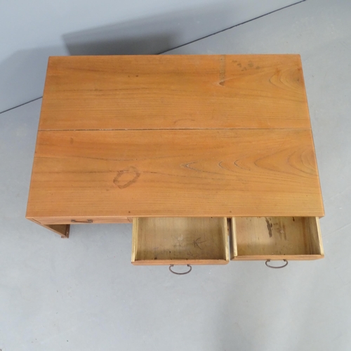 2703 - A Japanese pine low writing table with five drawers. 88x36x58cm.