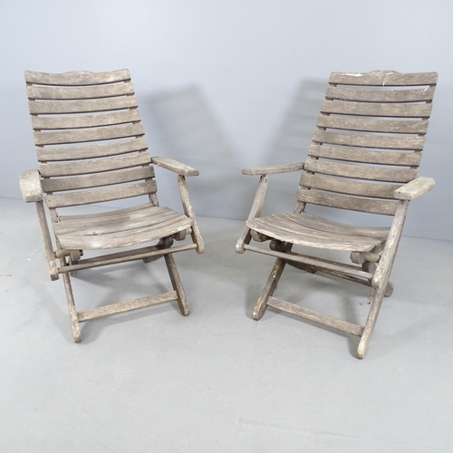 2723 - A pair of weathered teak steamer chairs, with label for Royal Heilag (?).