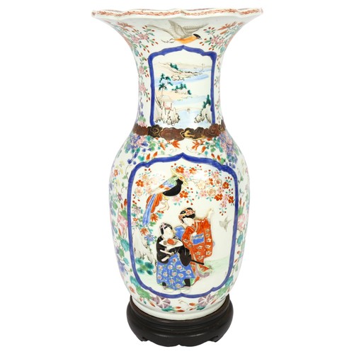 671 - A Chinese enamel decorated vase on turned wood stand, depicting birds and figures