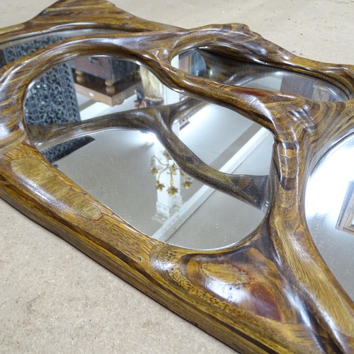 2350 - A contemporary hardwood framed abstract design wall mirror. 49x102cm.