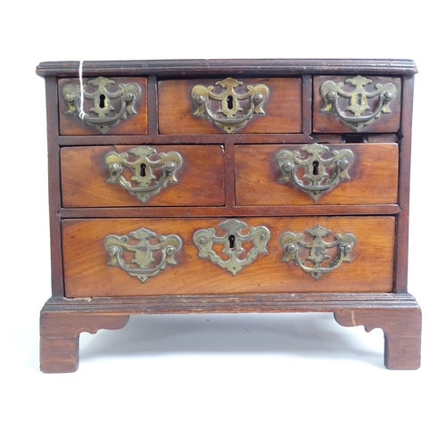 577 - An early 19th century table-top chest of 6 drawers of varying sizes, H29cm, L38cm, D20cm