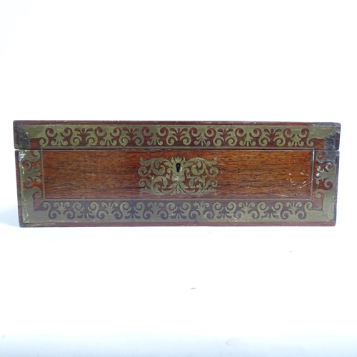 584 - A Regency rosewood and brass-bound travelling writing slope, with associated inkwells, and a coraman... 