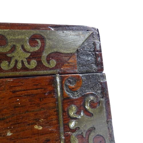 584 - A Regency rosewood and brass-bound travelling writing slope, with associated inkwells, and a coraman... 