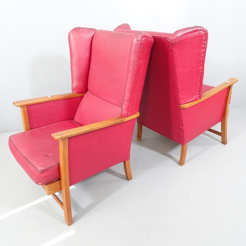 2112 - A pair of Parker Knoll style teak and faux-leather upholstered wingback armchairs.