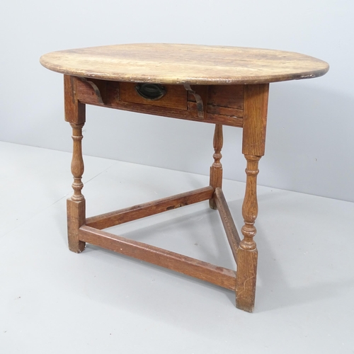 2051 - A 19th century oak circular topped cricket table with single frieze drawer. 75x62cm.