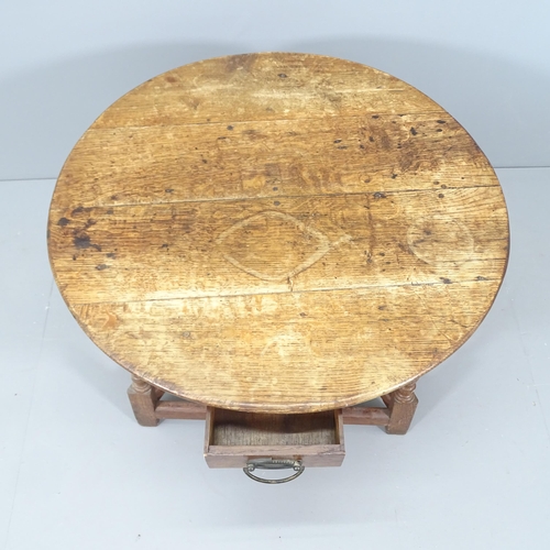 2051 - A 19th century oak circular topped cricket table with single frieze drawer. 75x62cm.