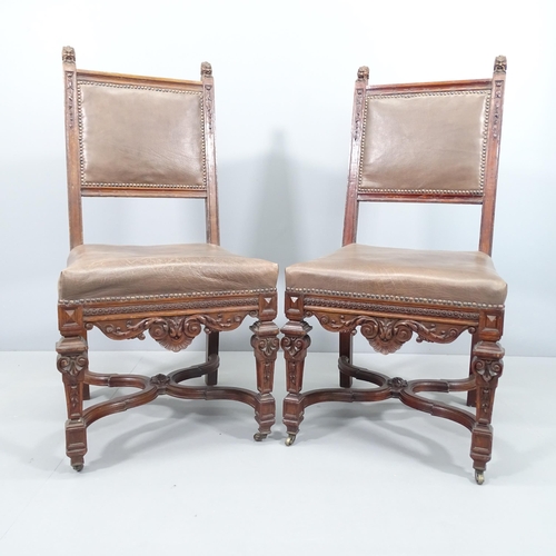 2057 - A pair of 19th century carved oak and leather upholstered Neo-Renaissance style dining chairs.