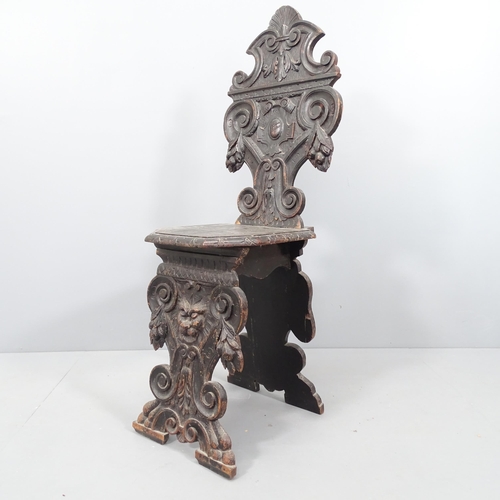 2072 - A 19th century Italian Renaissance Sgabello armorial carved oak hall chair, with green man decoratio... 