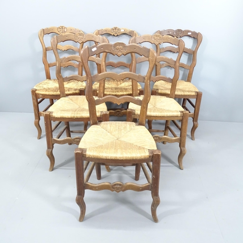 2076 - A set of six French oak ladder back dining chairs, with rush seats.