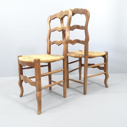 2076 - A set of six French oak ladder back dining chairs, with rush seats.