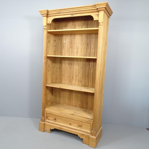 2079 - A modern pine open bookcase, with carved decoration, three adjustable and one spare shelf and drawer... 