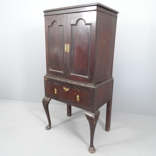 2081 - A 19th century two-section cabinet on stand, with two panelled doors revealing a shelved interior, s... 