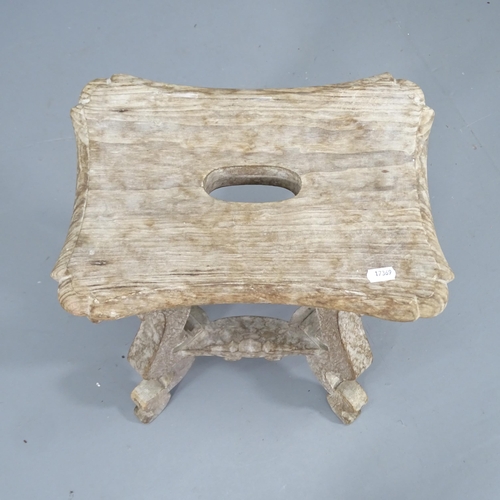 2084 - A continental limed oak stool. 38x58x28cm.