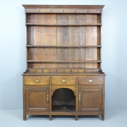 2086 - A George II oak two-section dresser, circa 1730, with open plate rack, eight drawers and cupboards u... 