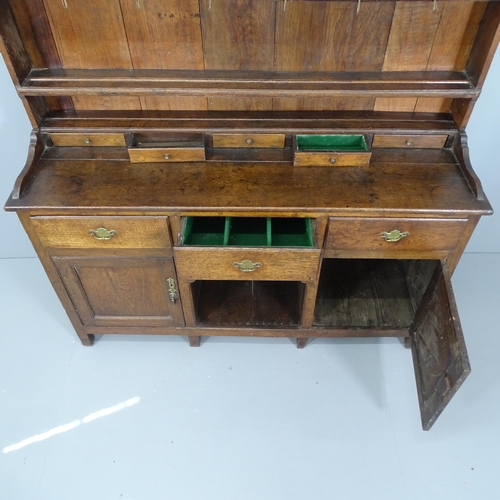 2086 - A George II oak two-section dresser, circa 1730, with open plate rack, eight drawers and cupboards u... 