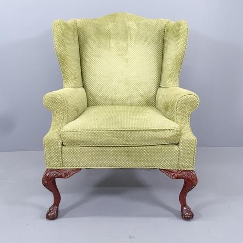 2092 - A mahogany and upholstered Queen Anne style wingback armchair, on cabriole legs with claw and ball f... 