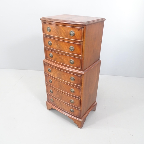 2094 - A reproduction mahogany bedside chest-on-chest in one section, with seven drawers and bracket feet. ... 