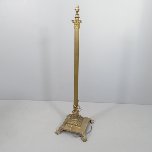 2104 - A brass Corinthian column standard lamp on platform base with claw and ball feet. Height to bayonet ... 