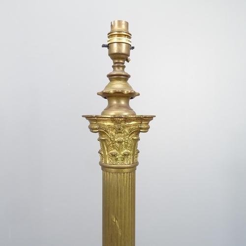 2104 - A brass Corinthian column standard lamp on platform base with claw and ball feet. Height to bayonet ... 