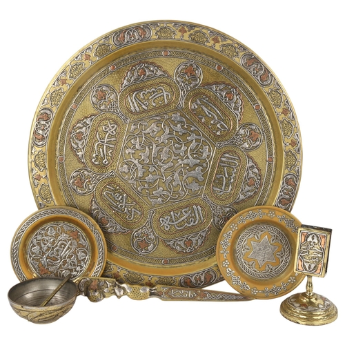 102 - A group of Persian brass items, comprising a circular tray, diameter 38cm, a relief cast paper knife... 