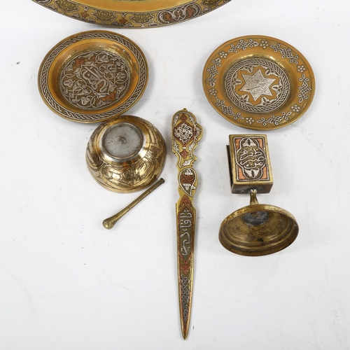 102 - A group of Persian brass items, comprising a circular tray, diameter 38cm, a relief cast paper knife... 