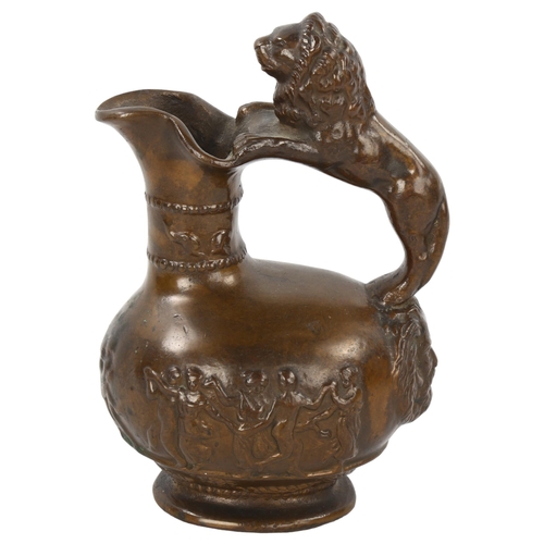 103 - A 19th century heavy cast patinated bronze Roman style wine ewer, with lion handle and relief moulde... 