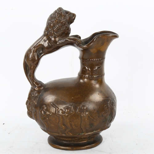 103 - A 19th century heavy cast patinated bronze Roman style wine ewer, with lion handle and relief moulde... 