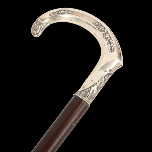 105 - A Continental silver-handled walking stick, with floral embossed handle