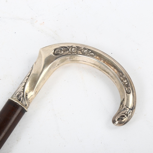 105 - A Continental silver-handled walking stick, with floral embossed handle