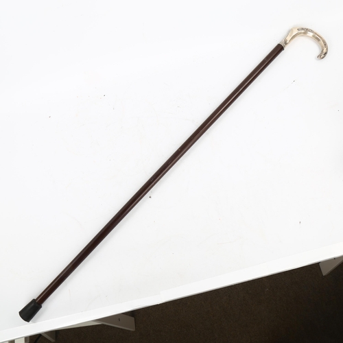 105 - A Continental silver-handled walking stick, with floral embossed handle