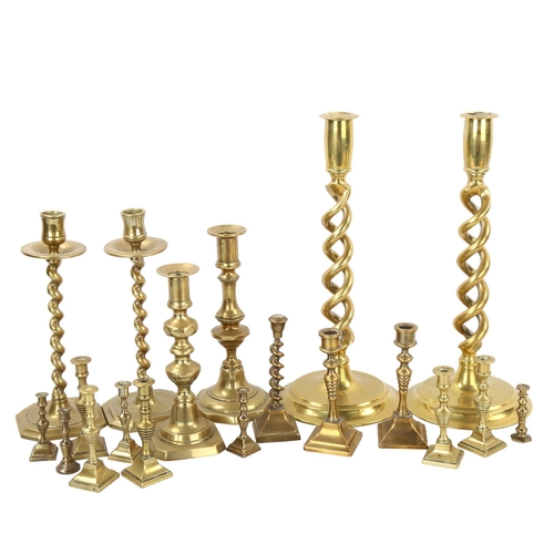 112 - A collection of brass candlesticks, including a pair of open twist, height 30cm