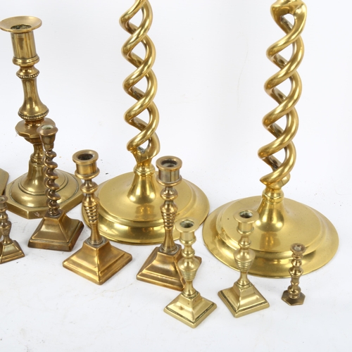 112 - A collection of brass candlesticks, including a pair of open twist, height 30cm