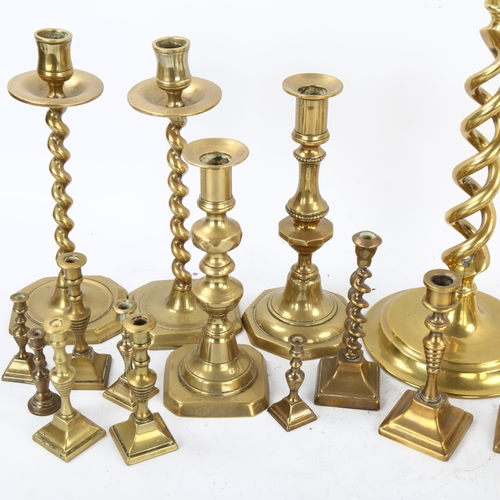 112 - A collection of brass candlesticks, including a pair of open twist, height 30cm