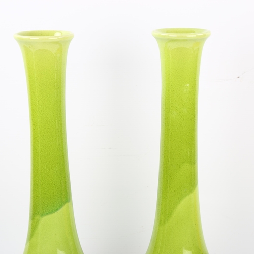 121 - A pair of pale green glaze Art pottery narrow-necked vases, impressed maker's marks, height 40cm