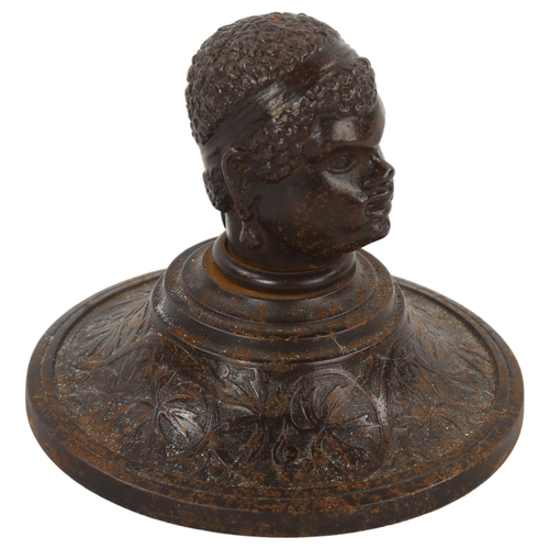 162 - A 19th century patinated iron paperweight, surmounted by a man's head, diameter 10cm