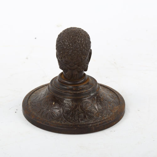 162 - A 19th century patinated iron paperweight, surmounted by a man's head, diameter 10cm