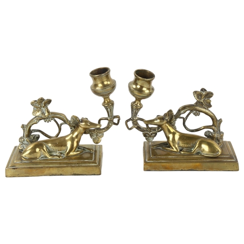 163 - A pair of 19th century brass candlesticks surmounted by Greyhounds, base length 13cm