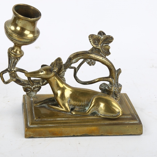 163 - A pair of 19th century brass candlesticks surmounted by Greyhounds, base length 13cm