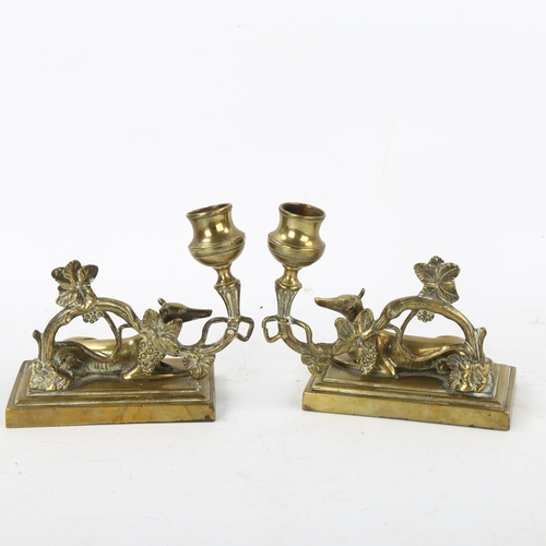 163 - A pair of 19th century brass candlesticks surmounted by Greyhounds, base length 13cm