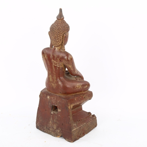 169 - A Burmese gilded and lacquered carved wood Buddha, 17th or 18th century, height 29cm